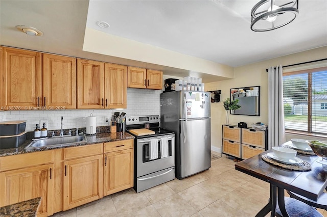 2435 Wilson St, Hollywood, FL 33020 - kitchen with appliances with stainless steel finishes, tasteful backsplash, light tile patterned floors, and dark stone countertops