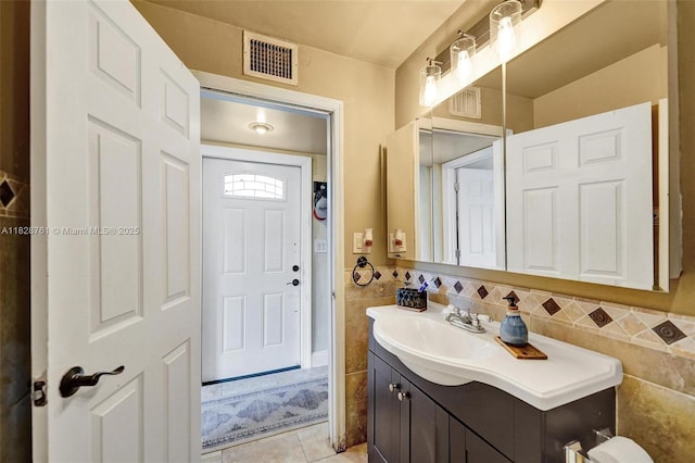 2435 Wilson St, Hollywood, FL 33020 - bathroom featuring vanity, tile patterned floors, and tile walls