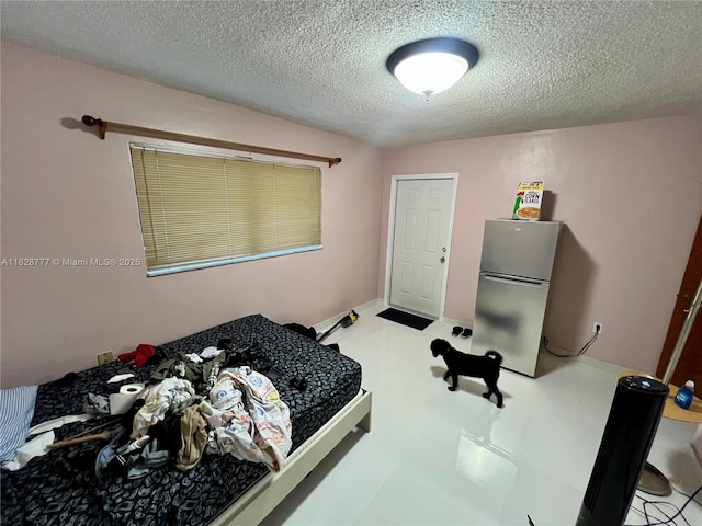 9601 SW 66th St, Miami, FL 33173 - bedroom with freestanding refrigerator and a textured ceiling