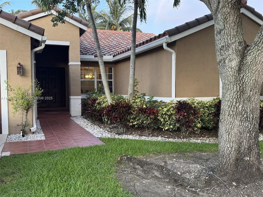 275 SW 198th Ter, Pembroke Pines, FL 33029 - view of exterior entry featuring stucco siding and a tile roof