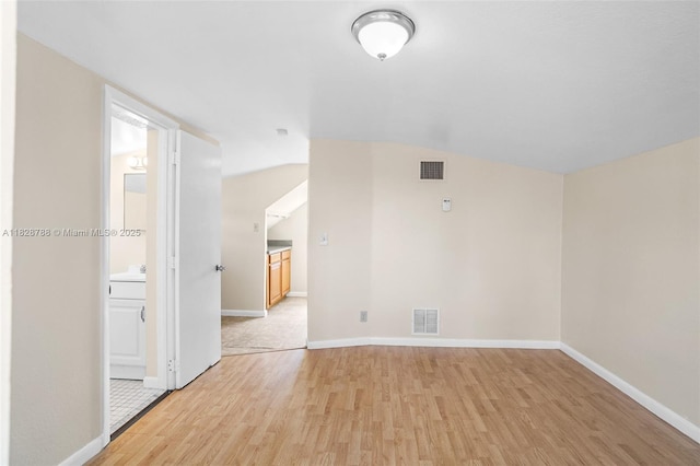 212 SW 11th St, Dania Beach, FL 33004 - spare room featuring light wood finished floors and vaulted ceiling