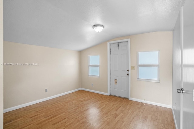 212 SW 11th St, Dania Beach, FL 33004 - spare room with vaulted ceiling and light wood finished floors