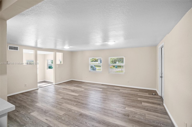 212 SW 11th St, Dania Beach, FL 33004 - spare room featuring wood finished floors and a textured ceiling