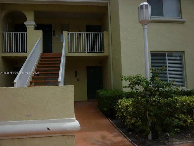 4106 Glenmoor Dr Unit 0, West Palm Beach, FL 33409 - doorway to property with stucco siding and a porch