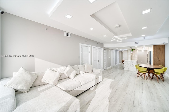 1800 S Ocean Dr Unit 3708, Hallandale Beach, FL 33009 - living area featuring a raised ceiling, light wood-style flooring, and a chandelier