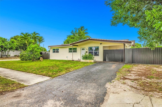 6601 Branch St, Hollywood, FL 33024 - ranch-style home featuring a tiled roof, asphalt driveway, and stucco siding