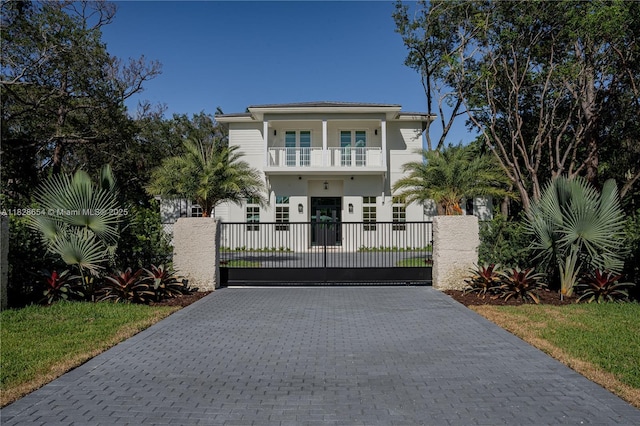 7605 SW 71st Ave, Miami, FL 33143 - view of front facade with a balcony, a gate, decorative driveway, and a fenced front yard