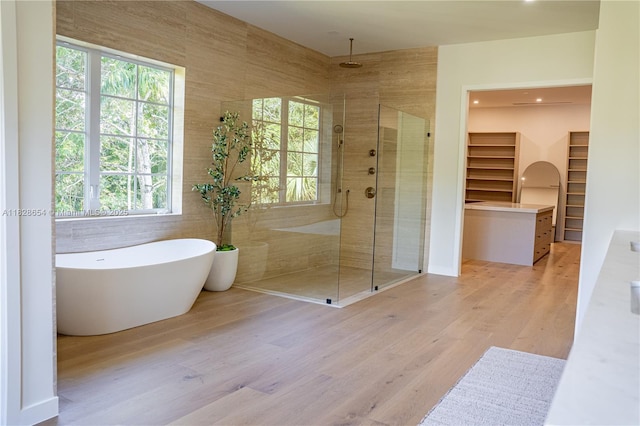 7605 SW 71st Ave, Miami, FL 33143 - bathroom with a shower stall, a walk in closet, a freestanding tub, and wood finished floors