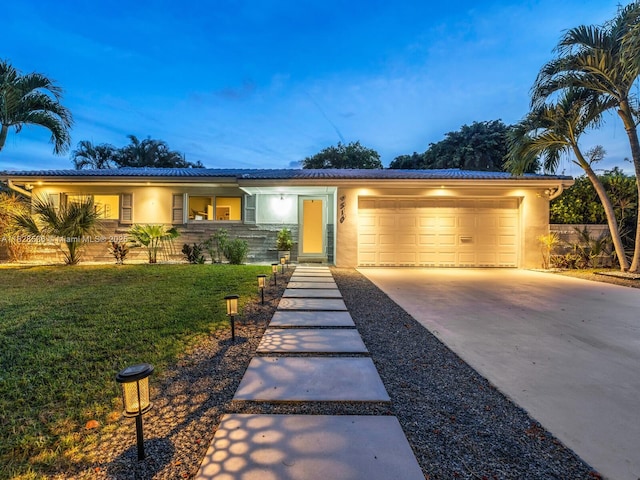 9510 NW 1st Ave, Miami Shores, FL 33150 - view of front facade featuring a garage, stucco siding, driveway, and a front lawn