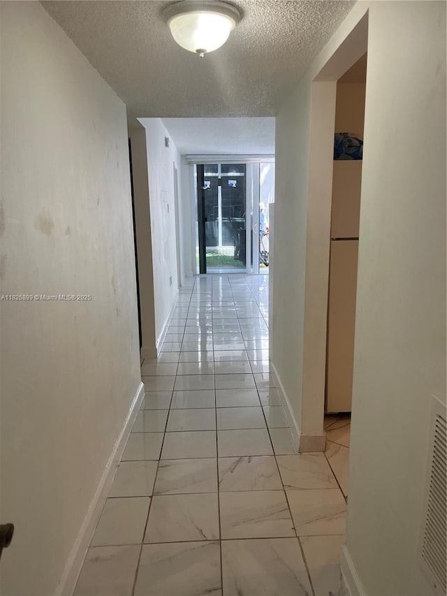 10000 NW 80th Ct Unit 2151, Hialeah Gardens, FL 33016 - corridor with a textured ceiling and light marble finish floors