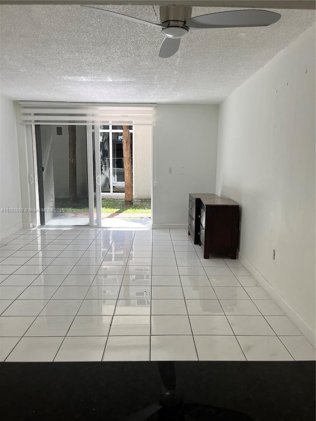 10000 NW 80th Ct Unit 2151, Hialeah Gardens, FL 33016 - spare room featuring a textured ceiling, ceiling fan, and light tile patterned floors