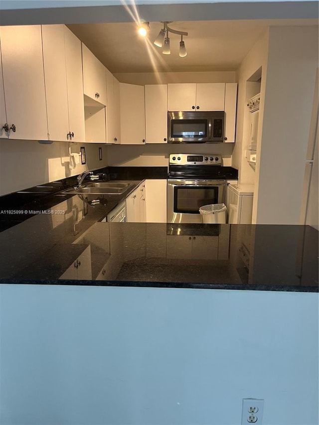 10000 NW 80th Ct Unit 2151, Hialeah Gardens, FL 33016 - kitchen with appliances with stainless steel finishes, a peninsula, white cabinets, and rail lighting