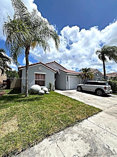 1988 SE 12th St, Homestead, FL 33035 - property entrance with stucco siding and a tile roof