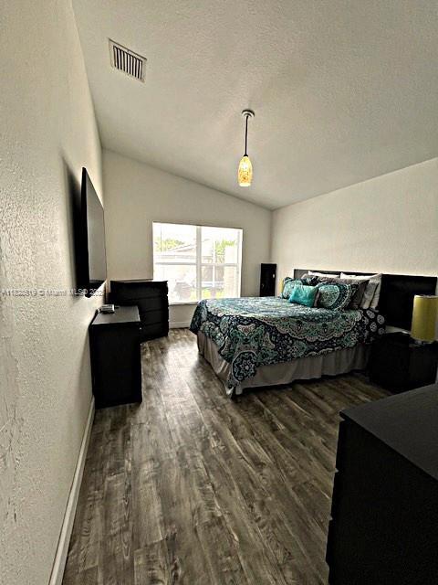 1988 SE 12th St, Homestead, FL 33035 - bedroom featuring vaulted ceiling and wood finished floors