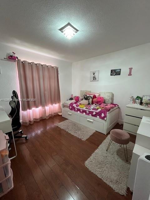 1988 SE 12th St, Homestead, FL 33035 - bedroom featuring wood finished floors and a textured ceiling