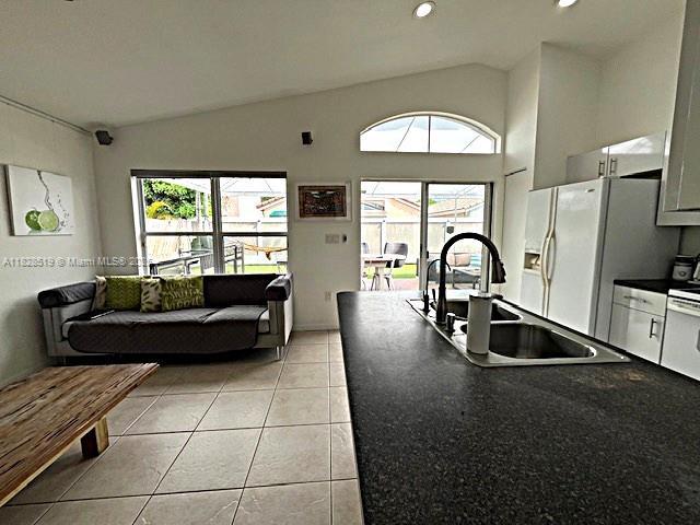 1988 SE 12th St, Homestead, FL 33035 - fenced backyard with a patio, an outdoor living space, and ceiling fan