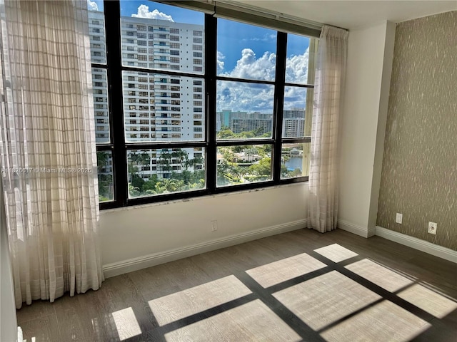 600 Three Islands Blvd Unit 1016, Hallandale Beach, FL 33009 - unfurnished room featuring a city view, healthy amount of natural light, and wood finished floors