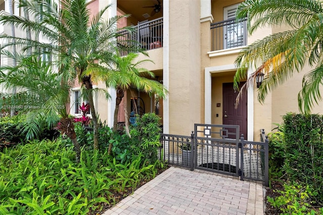3055 NW 126th Ave Unit 107, Sunrise, FL 33323 - doorway to property with stucco siding, a gate, and a balcony