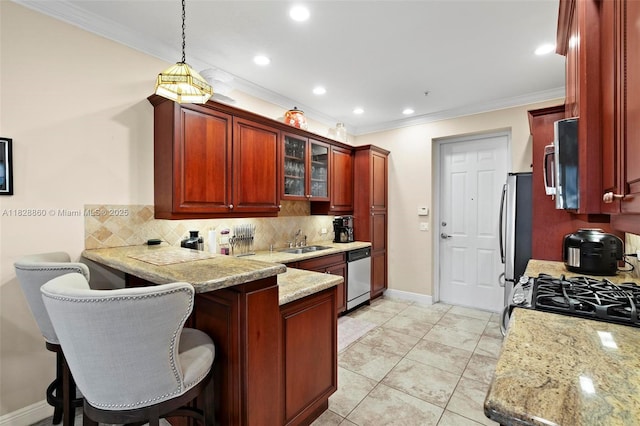 3055 NW 126th Ave Unit 107, Sunrise, FL 33323 - kitchen featuring appliances with stainless steel finishes, dark brown cabinets, backsplash, crown molding, and a peninsula