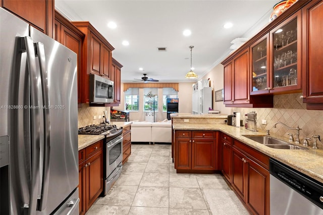 3055 NW 126th Ave Unit 107, Sunrise, FL 33323 - kitchen featuring appliances with stainless steel finishes, open floor plan, backsplash, ceiling fan, and a peninsula