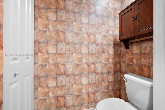 3055 NW 126th Ave Unit 107, Sunrise, FL 33323 - bathroom featuring toilet and tile walls