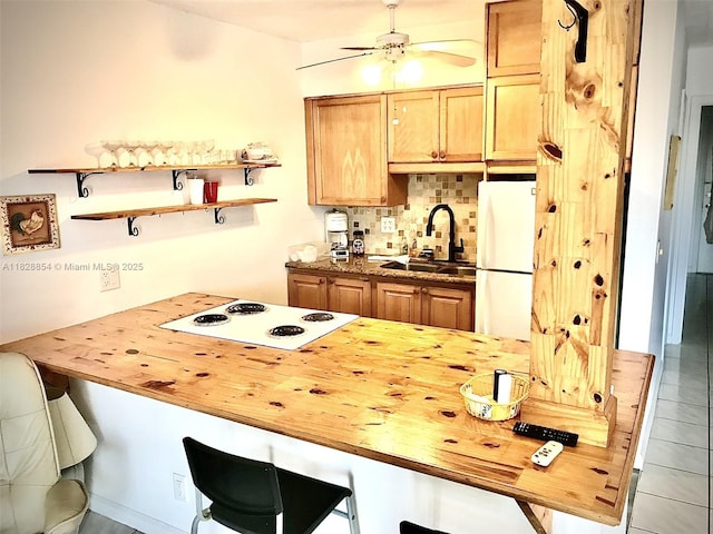 820 SW 11th Ave Unit 16B, Hallandale Beach, FL 33009 - kitchen featuring white appliances, butcher block countertops, decorative backsplash, a breakfast bar area, and a peninsula