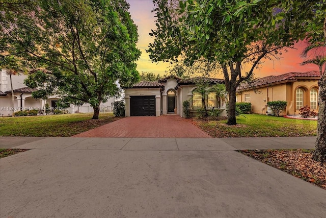 5046 SW 137th Ter, Miramar, FL 33027 - mediterranean / spanish house featuring decorative driveway, stucco siding, a tiled roof, and a yard