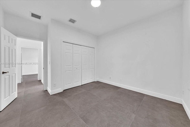 5046 SW 137th Ter, Miramar, FL 33027 - unfurnished bedroom with a closet and dark tile patterned floors