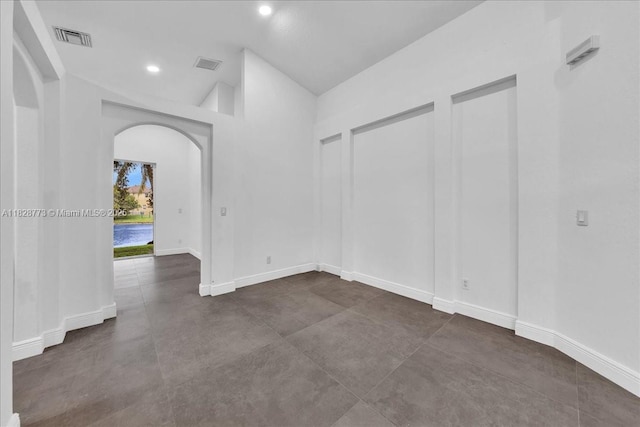5046 SW 137th Ter, Miramar, FL 33027 - empty room with arched walkways, vaulted ceiling, and recessed lighting