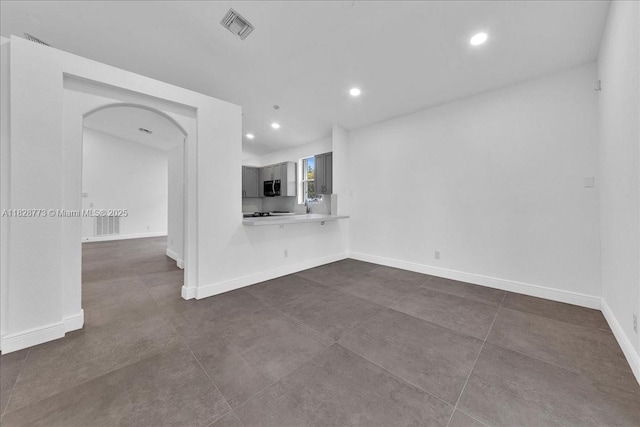 5046 SW 137th Ter, Miramar, FL 33027 - unfurnished living room featuring recessed lighting and arched walkways