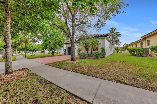 5046 SW 137th Ter, Miramar, FL 33027 - view of front of property featuring driveway, a front yard, a garage, and stucco siding