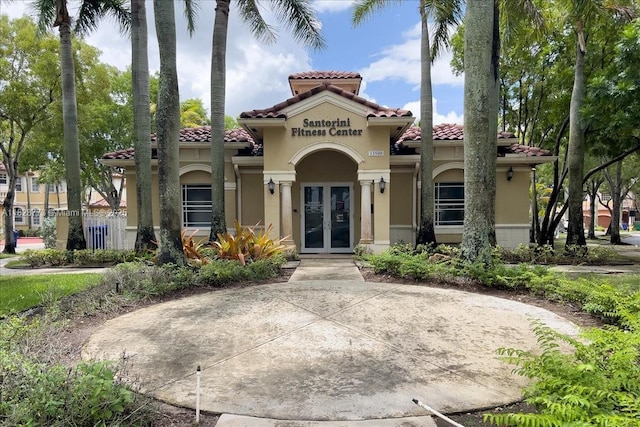 5046 SW 137th Ter, Miramar, FL 33027 - mediterranean / spanish home featuring french doors, a tiled roof, and stucco siding