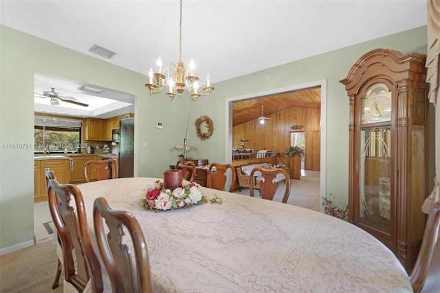 31260 SW 202nd Ave, Homestead, FL 33030 - dining room with light carpet, ceiling fan, a chandelier, lofted ceiling, and wood walls