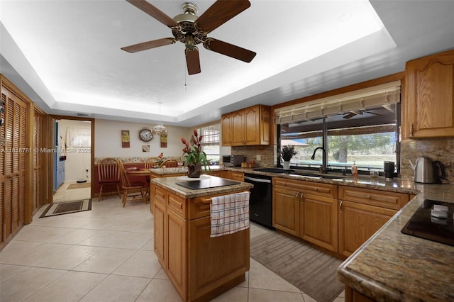 31260 SW 202nd Ave, Homestead, FL 33030 - kitchen featuring black appliances, a raised ceiling, light tile patterned flooring, tasteful backsplash, and a kitchen island