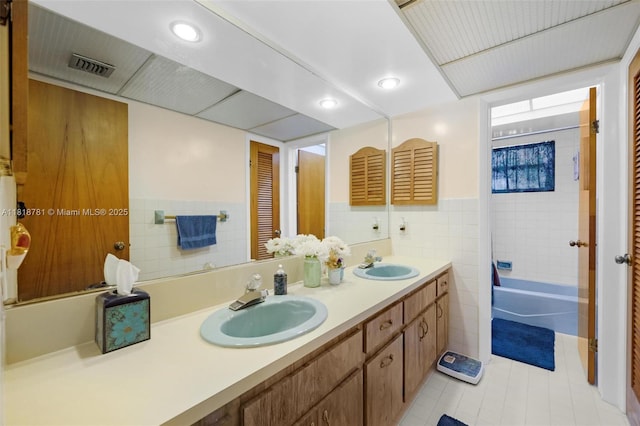 31260 SW 202nd Ave, Homestead, FL 33030 - bathroom with double vanity, tile walls, tile patterned flooring, bathing tub / shower combination, and recessed lighting