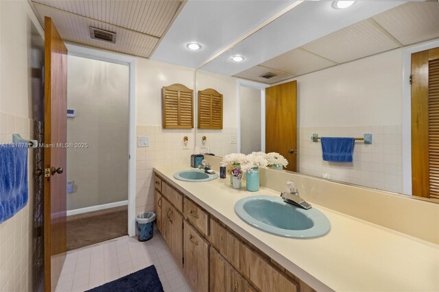 31260 SW 202nd Ave, Homestead, FL 33030 - full bathroom featuring tile walls, tile patterned floors, double vanity, and recessed lighting