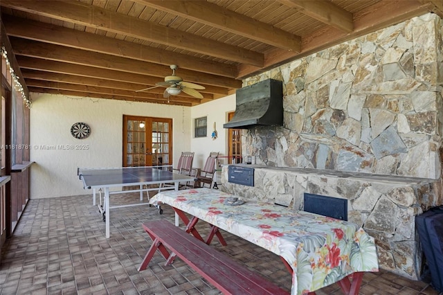 31260 SW 202nd Ave, Homestead, FL 33030 - dining space featuring french doors, a wooden ceiling with exposed beams, brick patterned floors, ceiling fan, and a fireplace