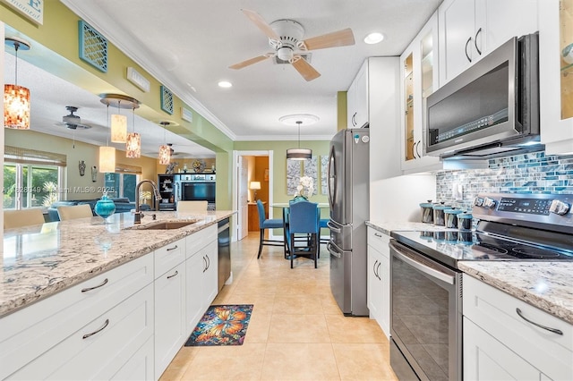 7306 NW 95th Way, Tamarac, FL 33321 - kitchen with appliances with stainless steel finishes, backsplash, white cabinetry, a ceiling fan, and crown molding