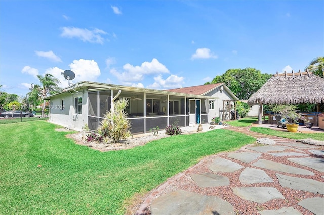 7306 NW 95th Way, Tamarac, FL 33321 - rear view of property with a sunroom, a gazebo, a yard, stucco siding, and a patio area