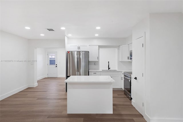 4290 NW 38th Ave, Lauderdale Lakes, FL 33309 - kitchen featuring stainless steel appliances, a center island, recessed lighting, white cabinets, and light countertops