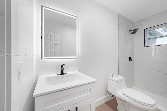 4290 NW 38th Ave, Lauderdale Lakes, FL 33309 - bathroom featuring vanity, a marble finish shower, and wood finished floors