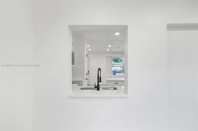 4290 NW 38th Ave, Lauderdale Lakes, FL 33309 - detailed view of recessed lighting, white cabinets, light countertops, and stainless steel microwave