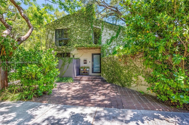 2427 Tequesta Ln, Miami, FL 33133 - obstructed view of property featuring stucco siding