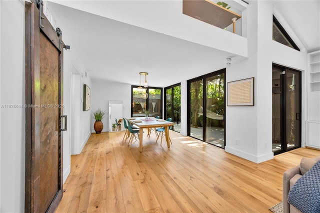 2427 Tequesta Ln, Miami, FL 33133 - dining area with light wood finished floors and a barn door