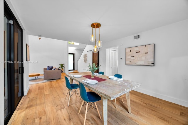 2427 Tequesta Ln, Miami, FL 33133 - dining room with light wood-style floors and baseboards