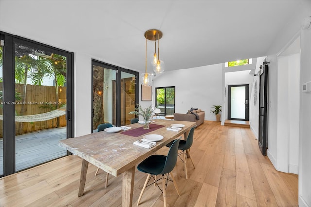 2427 Tequesta Ln, Miami, FL 33133 - dining room featuring light wood finished floors and a barn door