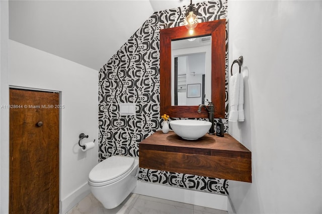 2427 Tequesta Ln, Miami, FL 33133 - bathroom with lofted ceiling, marble finish floors, and vanity