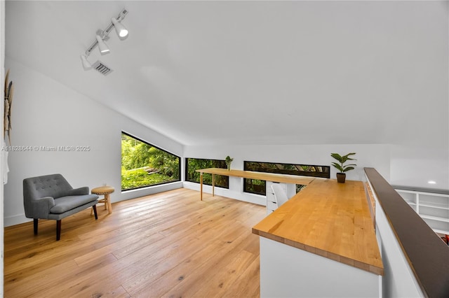 2427 Tequesta Ln, Miami, FL 33133 - sitting room with rail lighting, light wood-style floors, and an upstairs landing