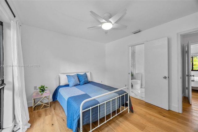 2427 Tequesta Ln, Miami, FL 33133 - bedroom featuring wood finished floors, connected bathroom, and a ceiling fan