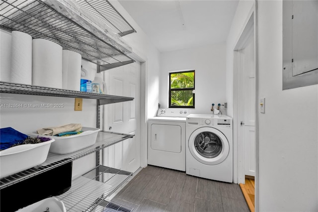 2427 Tequesta Ln, Miami, FL 33133 - laundry area with washing machine and clothes dryer, electric panel, and wood finished floors
